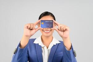 Young beautiful woman in formal clothing for officer with credit card photo