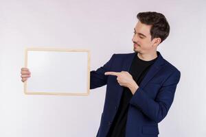 Portrait of happy businessman showing blank signboard on isolated white background photo