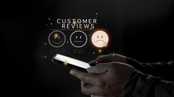 Customer Experience dissatisfied Concept, Unhappy Businessman Client with Sadness Emotion Face on smartphone screen, Bad review, bad service dislike bad quality, low rating, social media not good. photo