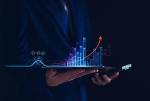 Economic analysis concept. Businessman analyze graph growth of business amid the global economic crisis, Strategy and planning, Recovery of business, Analyzing and data exchange on global networking. photo