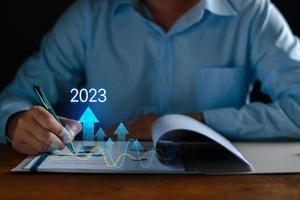 Growth and development chart of company in new year 2023. Planning, long term investment, opportunity, challenge and business strategy in new year 2023. Development to success and motivation. photo