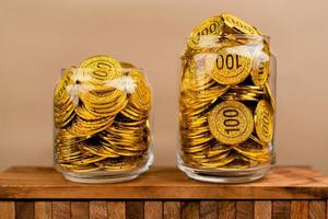 Saving gold. Saving money. Gold savings concept in a glass jar. Store gold in a glass jar. photo