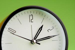 Alarm clock on green background, time concept, clock photo