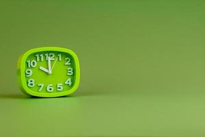 Alarm clock on green background, time concept, clock photo