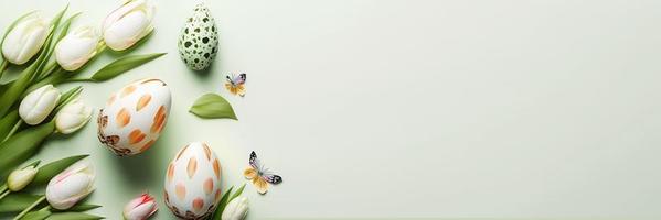 Decorated Tulips and Eggs On a Clean Background for An Easter Celebration Banner photo