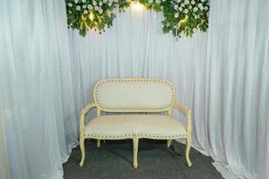 Aisle chairs or pre-wedding chairs with a white cloth background and green fake leaves photo