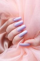 Girl's hands with a soft purple manicure. photo