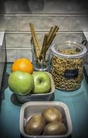Muesli and some fruit in the kitchen ready for preparing a healthy breakfast photo