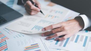 Analyst read business statistics chart reports, to analyze and improve corporate strategy, manage financial and marketing documents, update annual budget accounts, business data analysis concept photo