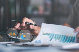 Analyst read business statistics chart reports, to analyze and improve corporate strategy, manage financial and marketing documents, update annual budget accounts, business data analysis concept photo