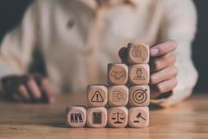 man touched wooden blocks stacked on table, document verification concept, ethics concept, Rules and policies, Terms and conditions, corporate governance documents, Regulations and compliance photo