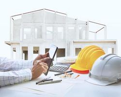 architect working table with house construction background photo