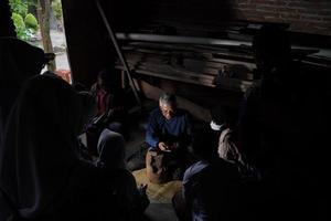 Keris craftsmen are teaching visitors about the process of making keris in the workshop. Bantul, Indonesia - 25 August 2022 photo