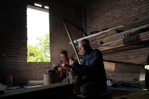 Keris craftsmen in the workshop, in the process of making keris. Bantul, Indonesia - 25 August 2022 photo