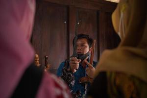 Visitors looking at a collection of kerises in a gallery. Bantul, Indonesia - 25 August 2022 photo