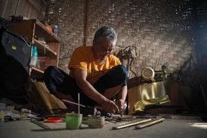 Craftsmen are making keris in the workshop. Javanese traditional weapon. Bantul, Indonesia - 25 August 2022 photo