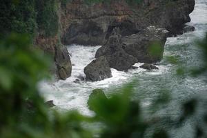 landscape views of cliffs and waves crashing into the reef. Very dangerous place. photo