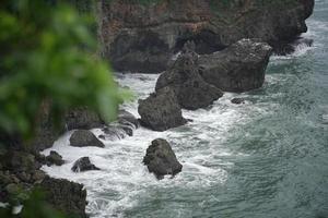 landscape views of cliffs and waves crashing into the reef. Very dangerous place. photo