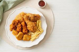 fried chicken with french fries and nuggets on plate photo