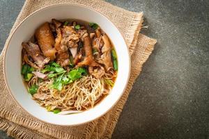 Stewed pork leg noodles in brown soup photo