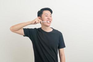 portrait young Asian man brush teeth