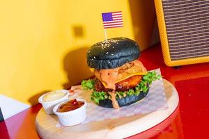 barbecue burger - pork with barbecue sauce with cheese, onion rings and bacon burger photo