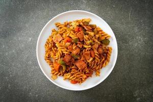 fusilli pasta with ham and tomatoes sauce photo