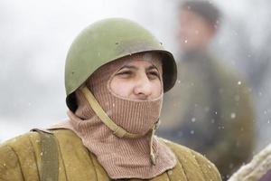 Belarus, Gomil, October 25, 2018 reconstruction of military operations. The face of a soldier in a mask and a protective helmet. photo