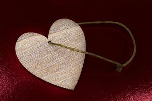 Vintage heart made of wood on a dark red background. photo