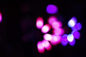 On a black background, pink and purple highlights and bokeh. photo