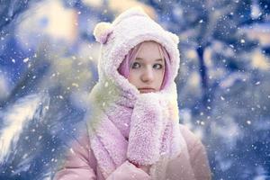 Fairytale portrait of a beautiful girl with pink hair on a winter background. photo