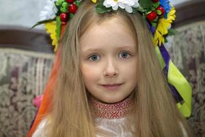 Belarus, city of Gomel, May 21, 2021 Children's holiday in the city. A little girl of Slavic appearance with a wreath of flowers on her head. photo