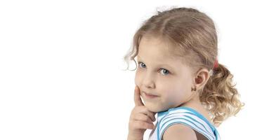 Close-up of a little girl's face. Portrait of a four-year-old girl on a white background. photo