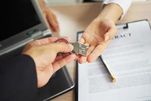 Home buyers are taking home keys from sellers. Sell your house, rent house and buy ideas. photo