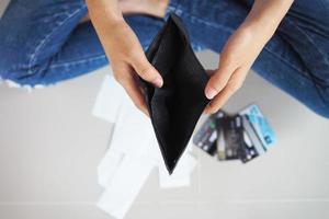 Women sit with strained credit card debt. Because there is no money left in the wallet. photo