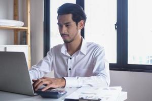 Asian businessmen use keyboards with notebooks on the table. Concepts of education and internet communication photo