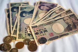Japanese yen notes and Japanese yen coins for money concept background. photo