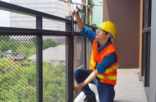 el inspector o ingeniero está inspeccionando y midiendo el tamaño de la terraza del edificio. foto