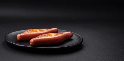 Composite concept of fried eggs inside a cut sausage with spices photo