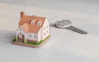 House key and house model on wooden floor.Concept for real estate,property,agent.3d rendering photo