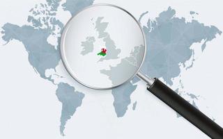 World map with a magnifying glass pointing at Wales. Map of Wales with the flag in the loop. vector