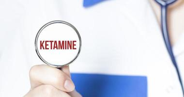 Sign ketamine and hand with stethoscope of Medical Doctor photo
