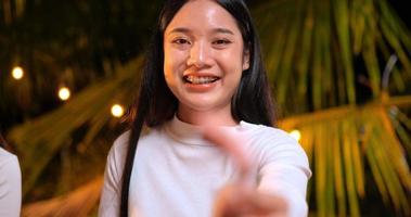 Footage of Happy Asian friends having dinner party together - Young people sitting at bar table toasting beer bottle dinner outdoor  - People, food, drink lifestyle, new year celebration concept. video