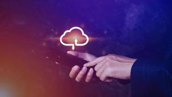 Businessman holding smartphone with virtual cloud computing to transfer database information upload, download application. technology business transformation concept. photo