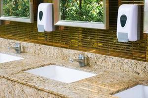 Toilet sink interior of public toilet with of washing hands and mirror golden,clean toilet photo