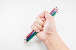 Colorful Pencil  in fist   power of written word on white background photo