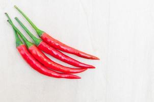 fresh red hot chilli peppers with spicy on the wooden photo