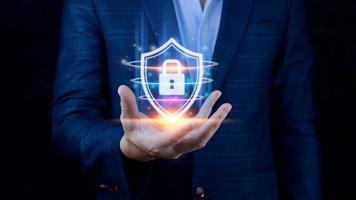 Computer network protection, secure and safe your data concept, businessman holding shield protection icon, Security shield Lock Security Businessman Protect Concept photo