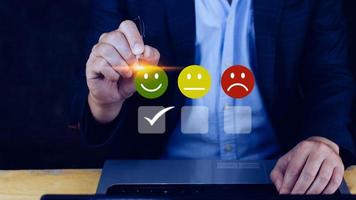 Businessman choosing happy smile face icon. feedback rating and positive customer review experience, satisfaction survey. mental health assessment. World mental health day concept photo