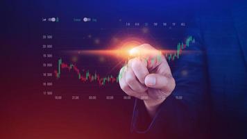 Businessman finger touch symbol stock graph and chart background, concept growth and development business investment, Stock market and strategy making market plan and stock market fluctuations photo